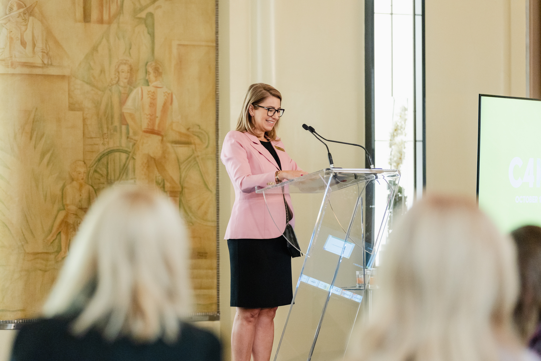 A woman delivering a captivating speech at a conference.