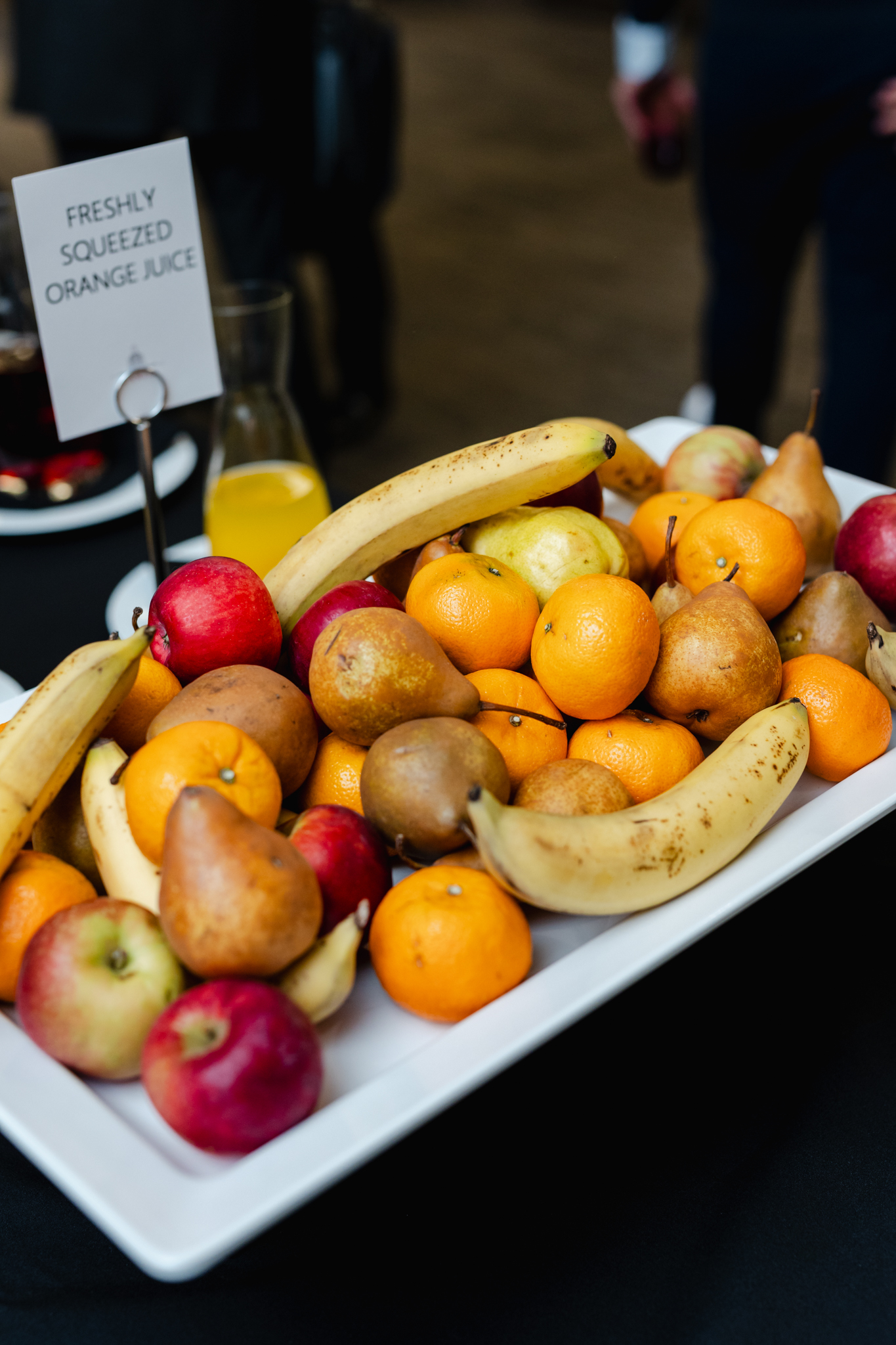 A tray of fruit on a table captured through conference photography.
