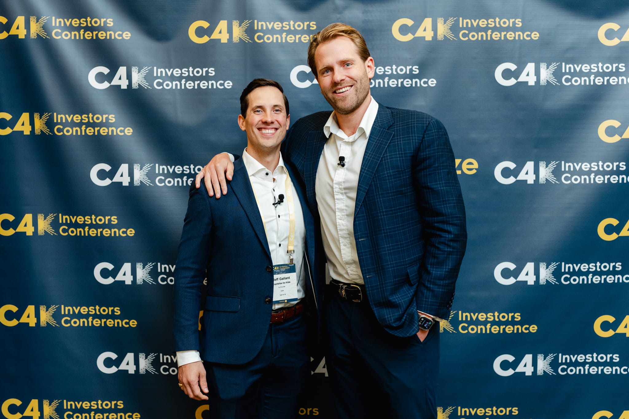 Two men standing next to each other at the conference.