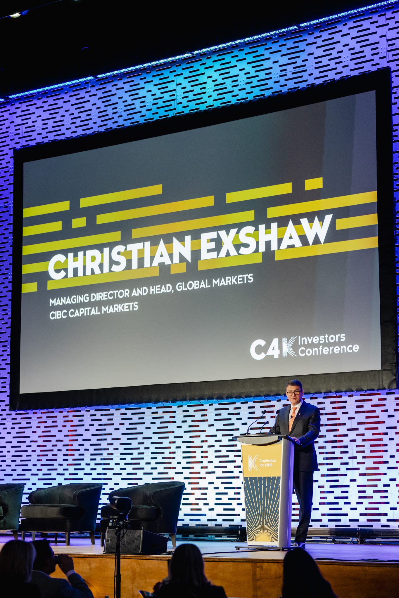 Christian Exshaw speaking on stage at the global markets conference.