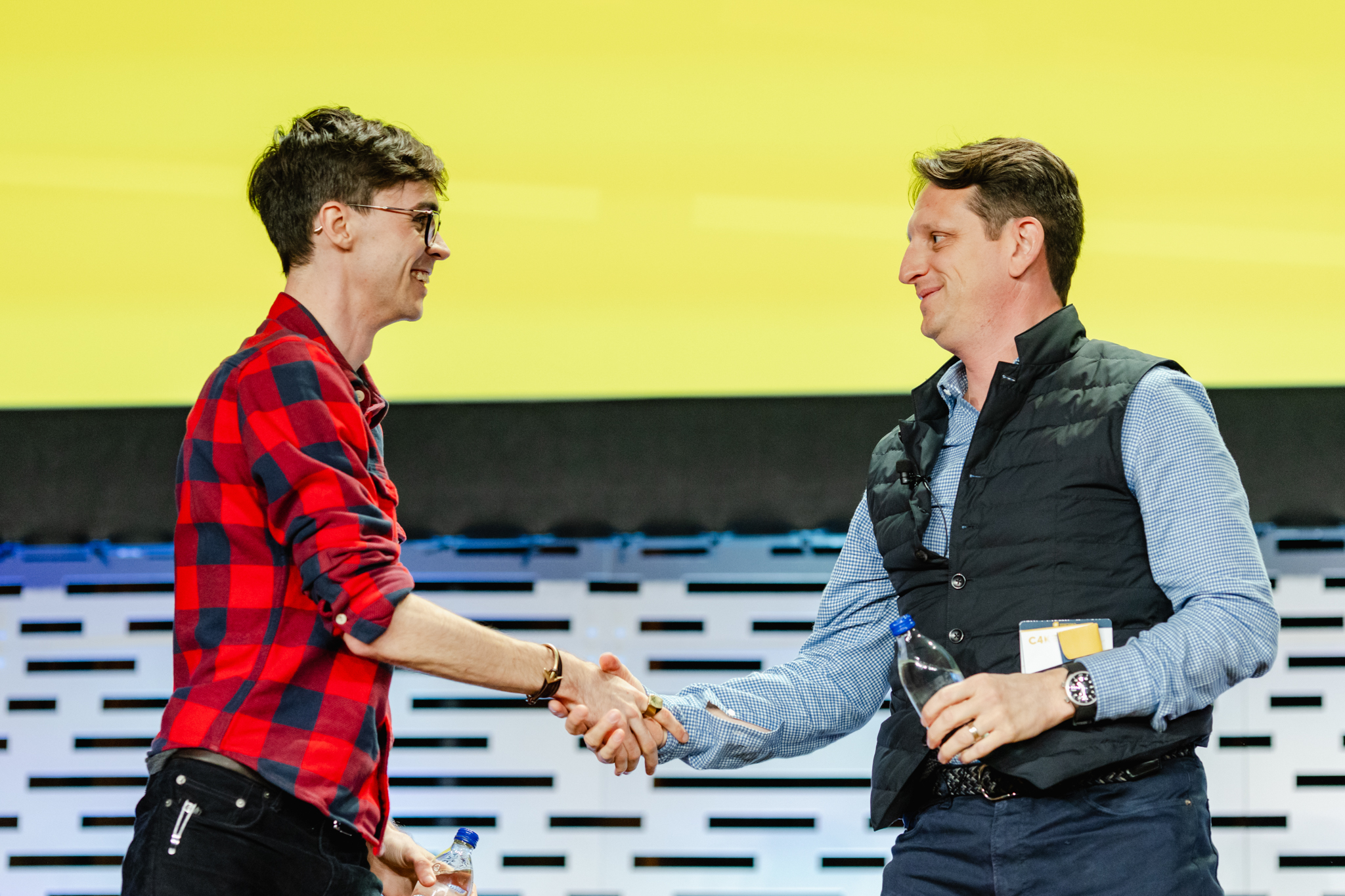 Two men shaking hands during a conference.