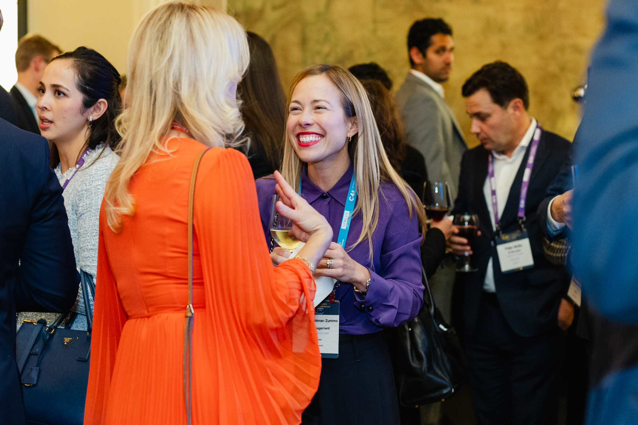Conference attendees engaged in lively conversations during a business event.