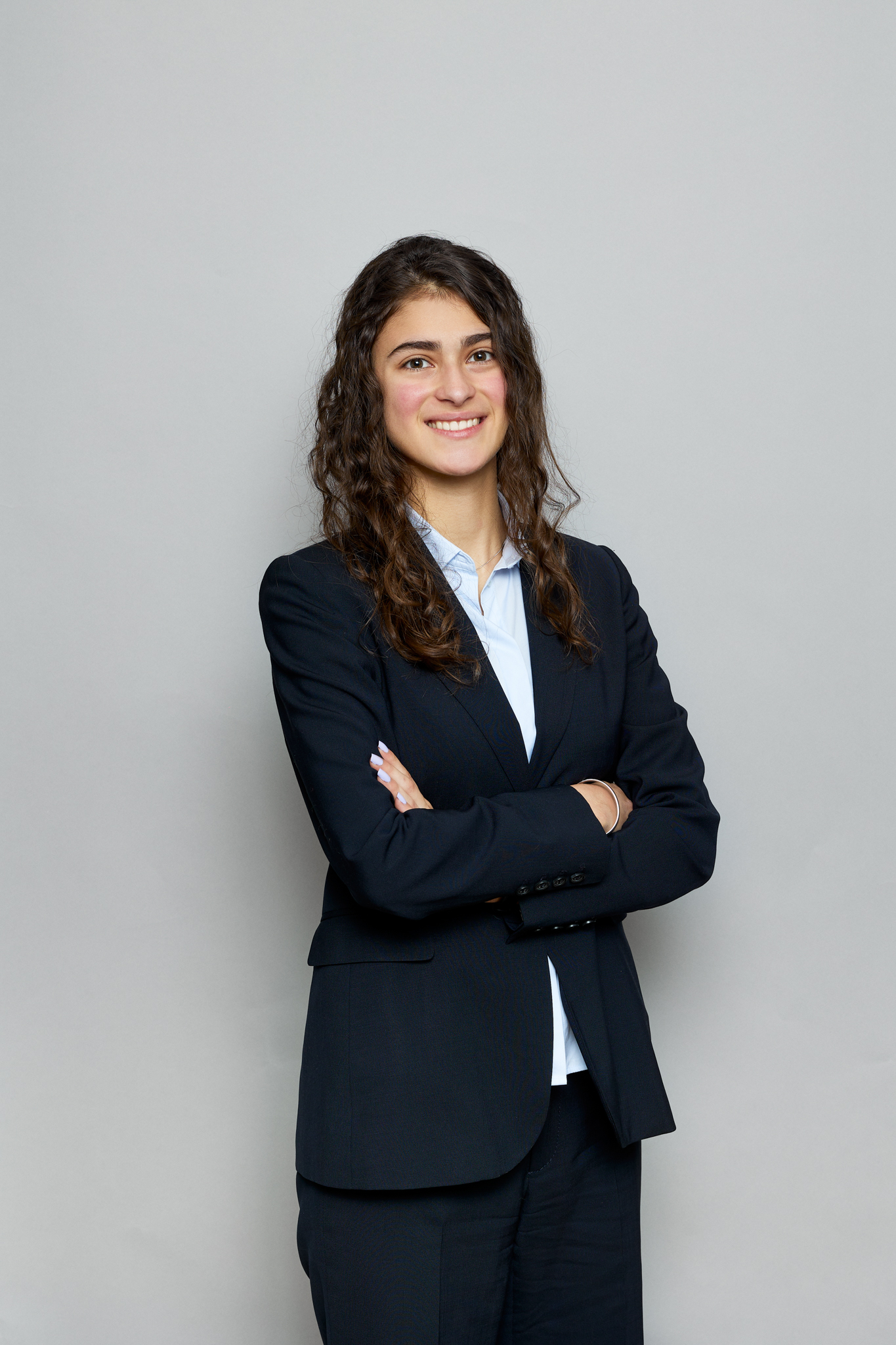 A young woman in a business suit posed for a photo during an event.