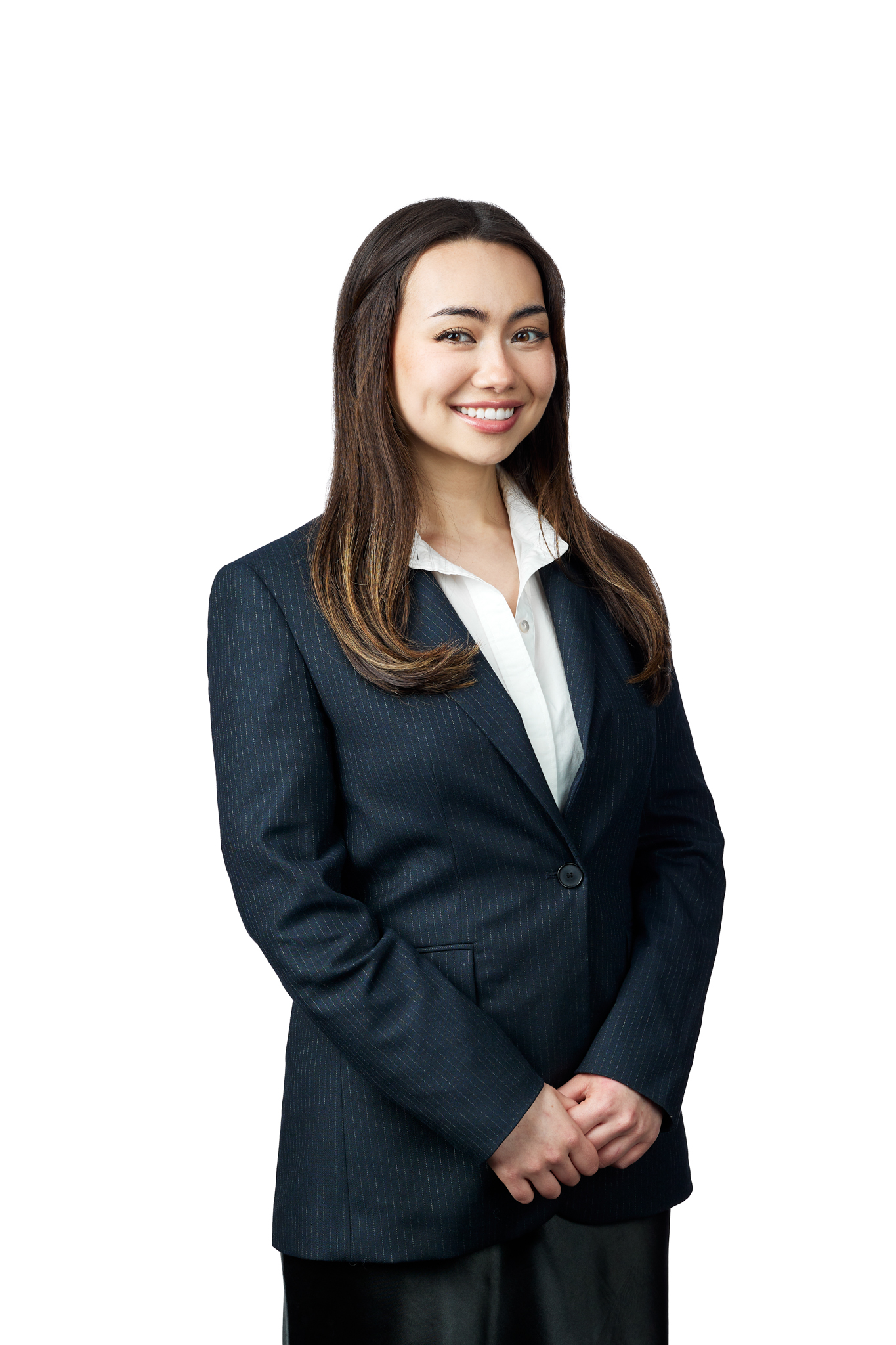 A woman in a business suit posing for event photography.
