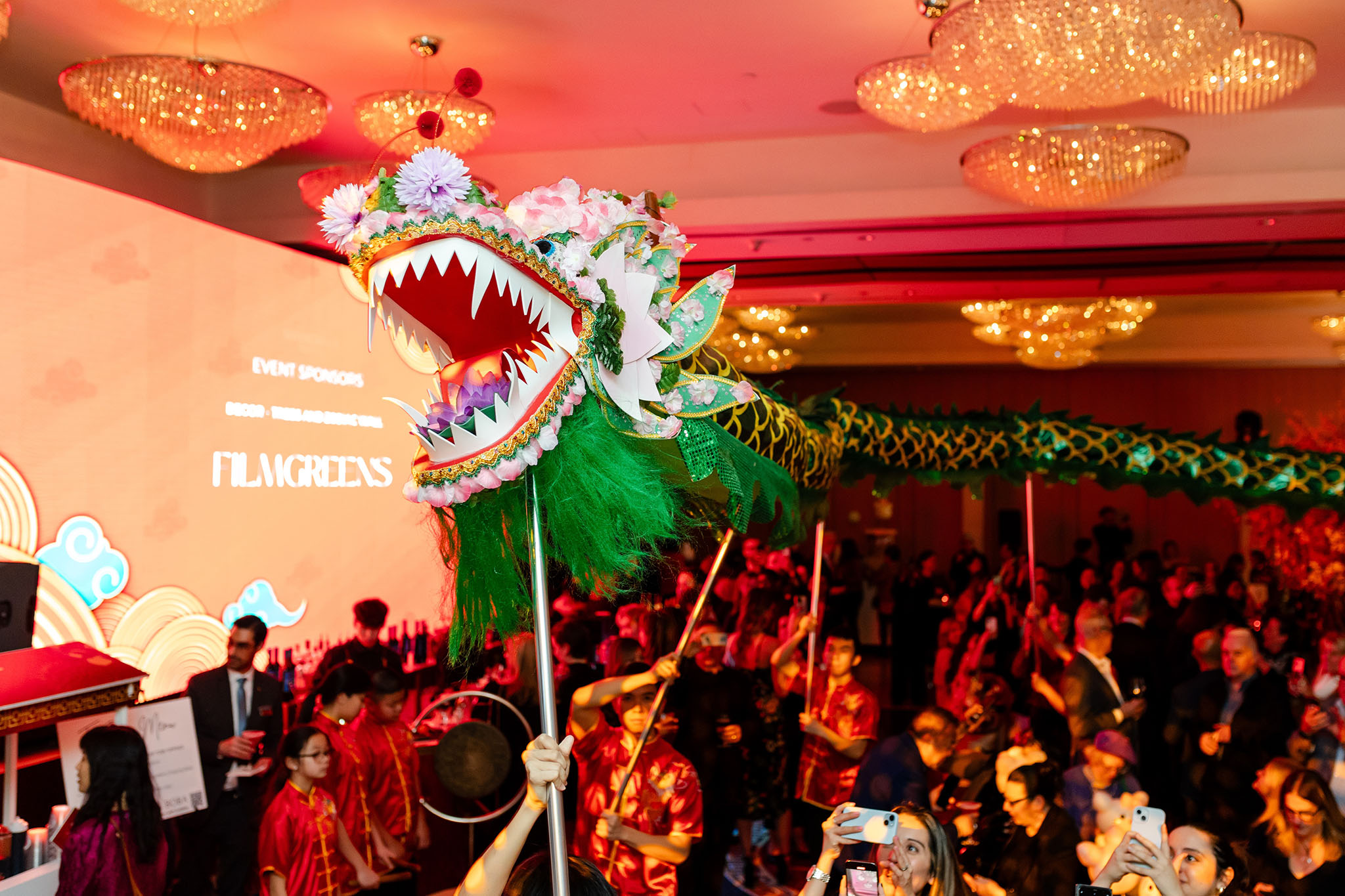 Corporate photography at a Chinese event featuring a dragon in the background.