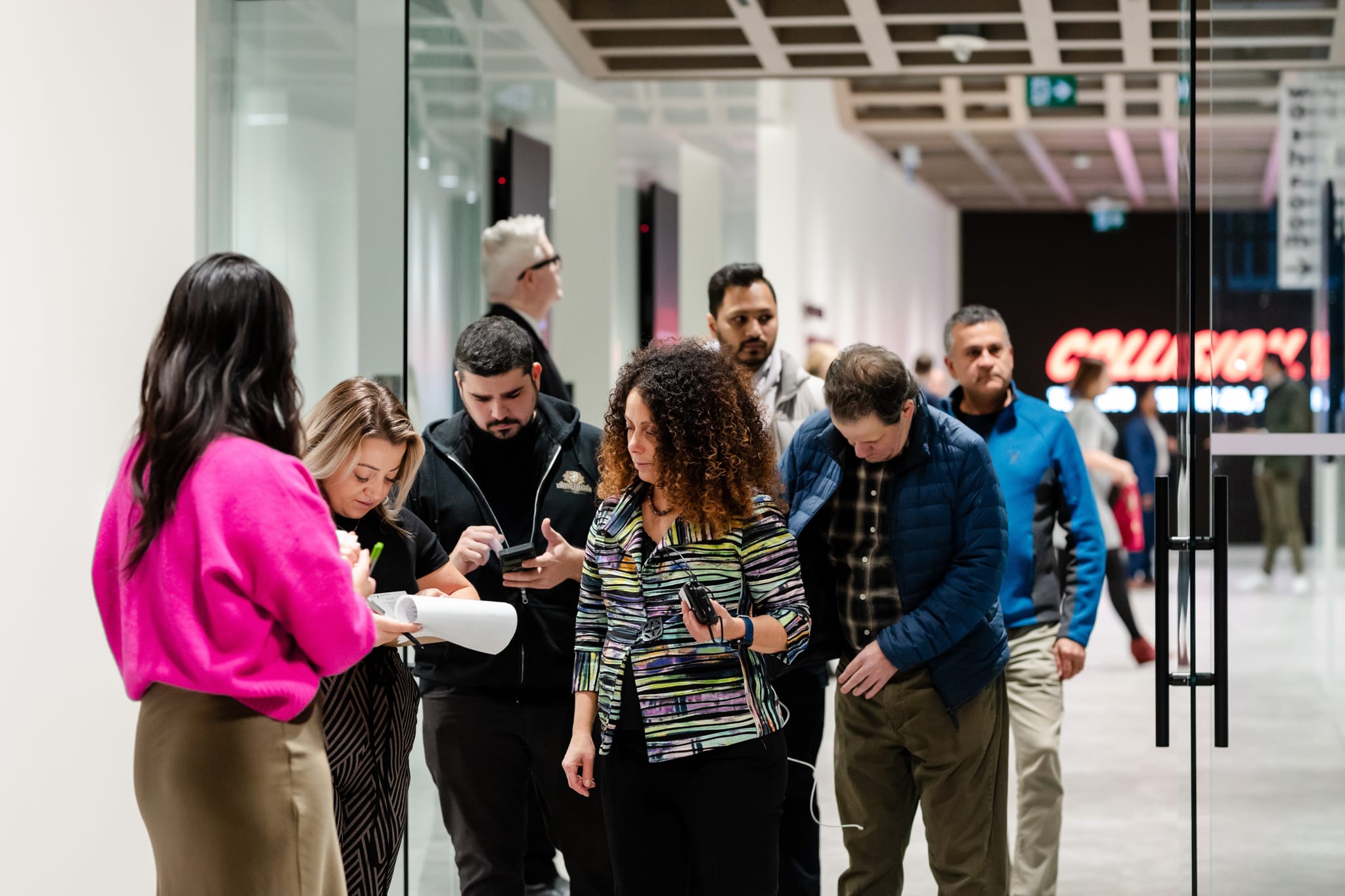 People gathered in a hallway for an event.