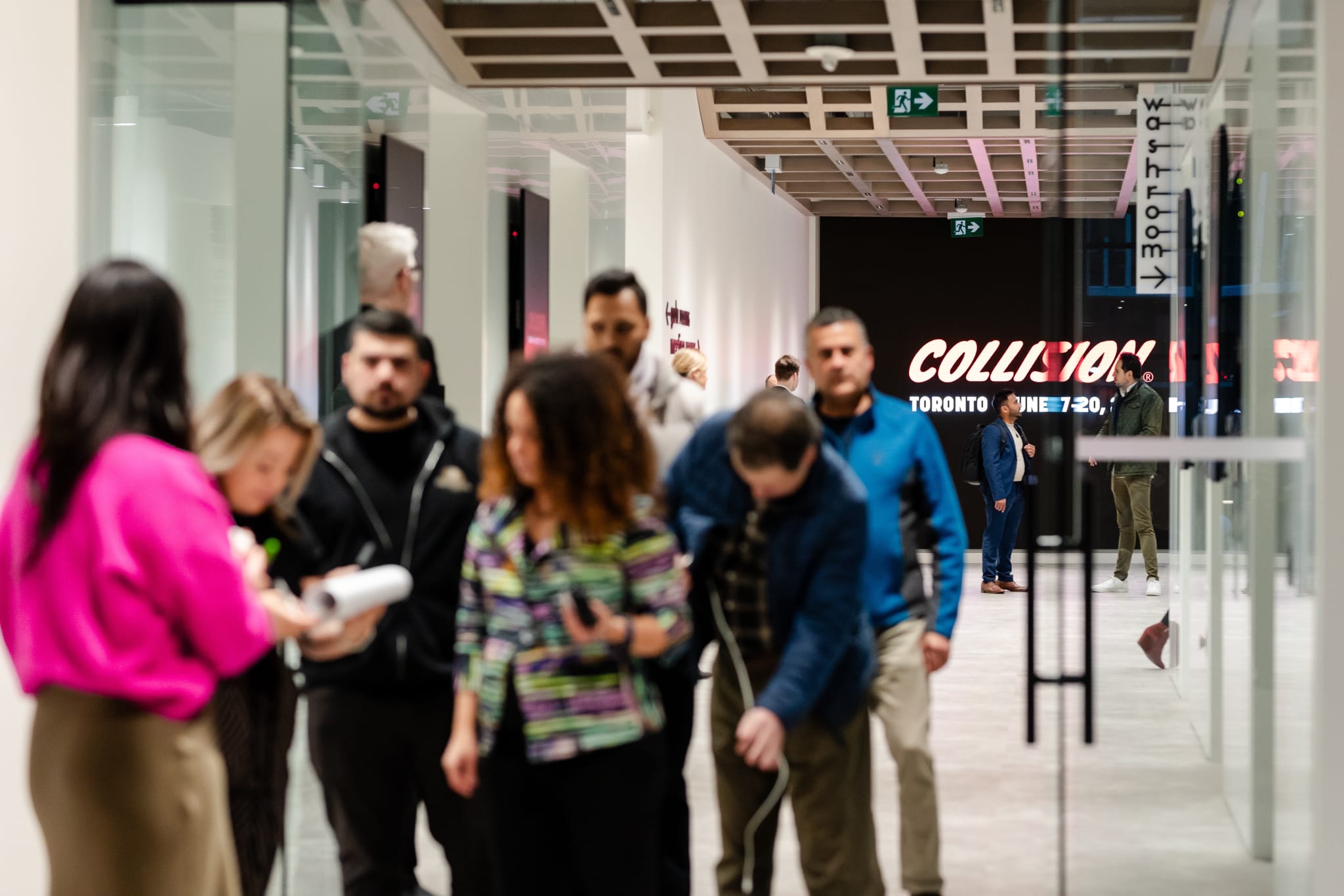 Event photography capturing a group of people walking down a hallway in an office building.