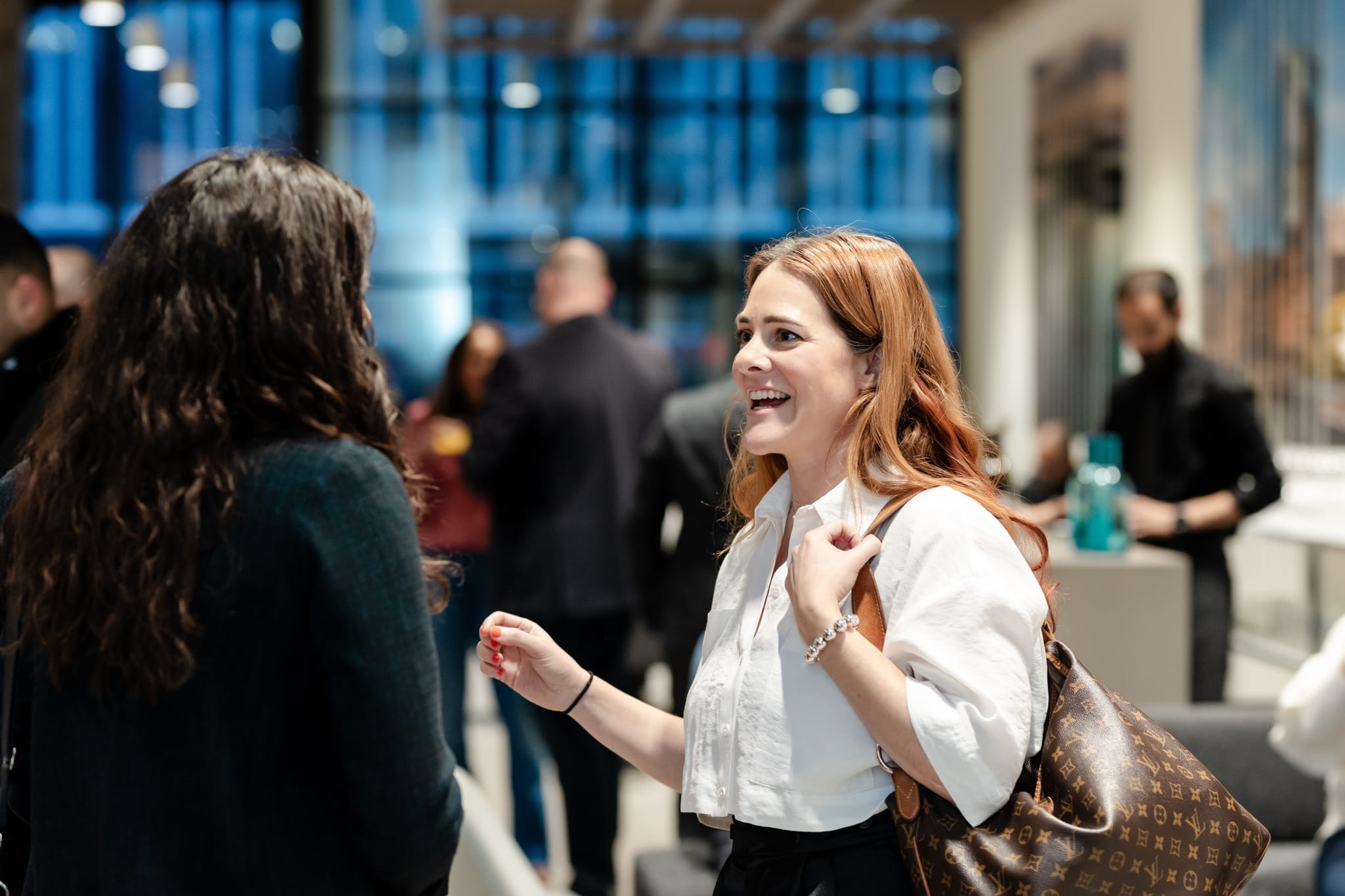 Two women chatting at an event.