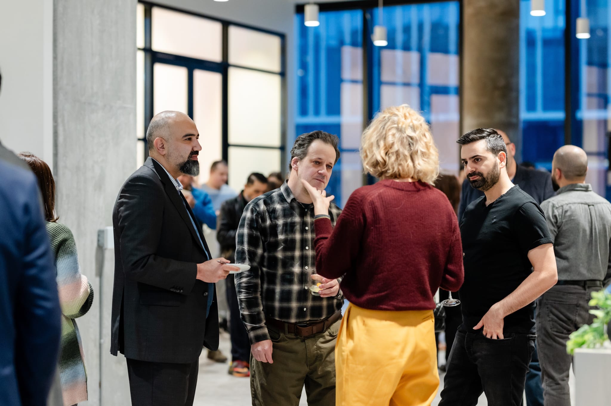 A group of people engaging in conversation at an event.