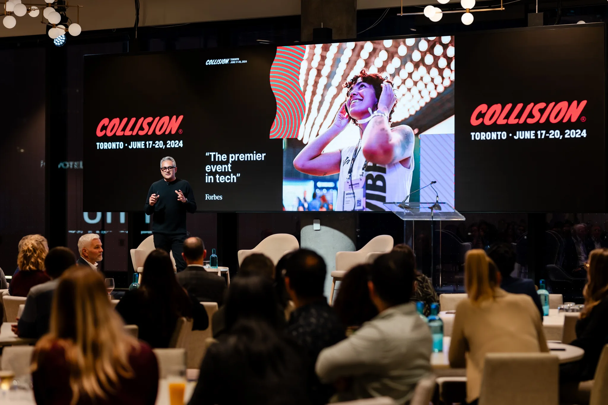 A man is presenting to a group of people at an event.
