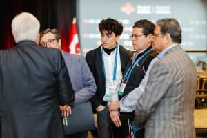 A group of professionals engaged in a serious discussion at a conference event featuring event photography.