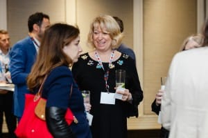 Two attendees engaging in a conversation at a networking event captured by event photography.