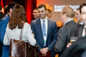 A group of professionals engaging in conversation at a networking event featuring event photography.