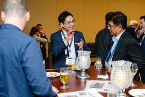 Business professionals engaging in conversation at a networking event, captured by event photography.
