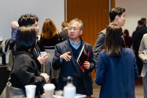 Professionals engaging in conversation at an event photography networking event.