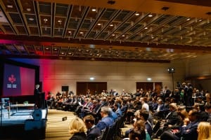 Audience attending a presentation in a conference hall during an event photography session.