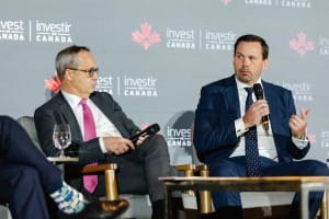 Two men participating in a panel discussion at an Invest Canada event, captured in stunning event photography.