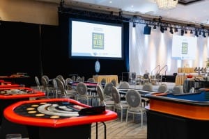 A large room with tables and chairs set up for event photography.