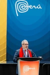 A man standing at a podium during an event photography session.