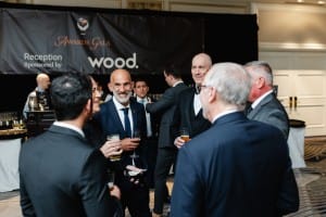 A group of people at an event, engaging in conversation, captured through event photography.