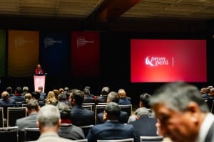 A man giving a speech in front of an audience at an event.
