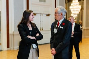 A man and a woman talking in a ballroom during an event photography session.