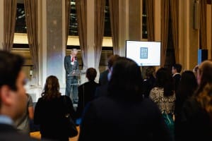 A group of people standing at a podium during an event photography session.
