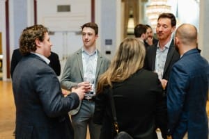A group of business people talking at a photography event.